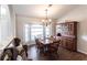 Formal dining room with ample seating, a large bay window, and traditional wood furniture at 52 Mariner Ln, Rotonda West, FL 33947