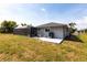 Exterior view of the house showcasing the lanai, and backyard at 52 Mariner Ln, Rotonda West, FL 33947