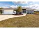 Charming single-story home featuring a well-maintained lawn and a welcoming entryway at 52 Mariner Ln, Rotonda West, FL 33947