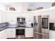 Well-equipped kitchen featuring stainless steel appliances and sleek white cabinetry at 52 Mariner Ln, Rotonda West, FL 33947