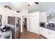 Bright kitchen with stainless steel appliances, white cabinetry and hard wood flooring at 52 Mariner Ln, Rotonda West, FL 33947