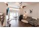 Cozy living room featuring vaulted ceilings, tile floors, and access to the outdoor lanai at 52 Mariner Ln, Rotonda West, FL 33947