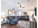 Cozy living room with a large sectional sofa, decorative mirrors, and a ceiling fan at 52 Mariner Ln, Rotonda West, FL 33947