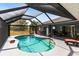 A private outdoor pool and deck are accessible from the home via a screened in patio at 52 Mariner Ln, Rotonda West, FL 33947