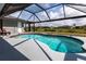 Backyard screened-in pool overlooking the lawn provides for hours of fun in the sun at 52 Mariner Ln, Rotonda West, FL 33947