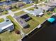 Aerial view of waterfront property with dock and solar panels on the roof at 5266 Cooper Ter, Port Charlotte, FL 33981