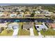 An aerial view reveals a well-maintained home with a spacious yard and easy canal access at 5266 Cooper Ter, Port Charlotte, FL 33981