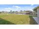 Beautiful backyard with a canal view, boat dock, and lush green grass at 5266 Cooper Ter, Port Charlotte, FL 33981