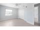 Spacious bedroom with tile flooring, ceiling fan, window, and closet doors at 5266 Cooper Ter, Port Charlotte, FL 33981