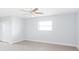 Bright bedroom with ceiling fan, neutral walls and floors, and a closet at 5266 Cooper Ter, Port Charlotte, FL 33981