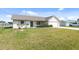 Home's exterior with well-manicured lawn, inviting entrance and attached two car garage at 5266 Cooper Ter, Port Charlotte, FL 33981