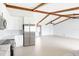 Modern kitchen features an open floorplan, stainless appliances, white cabinets, and wood beam ceilings at 5266 Cooper Ter, Port Charlotte, FL 33981