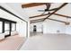 Open-concept living room with exposed beams, neutral floors and updated kitchen at 5266 Cooper Ter, Port Charlotte, FL 33981