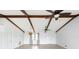 The open-concept living room features exposed beams, a ceiling fan, and neutral paint at 5266 Cooper Ter, Port Charlotte, FL 33981
