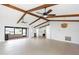 A spacious living room features exposed beams, ceiling fans, and neutral tiling at 5266 Cooper Ter, Port Charlotte, FL 33981