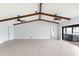 The spacious living room features exposed beams, recessed lighting, and easy access to outdoor hot tub at 5266 Cooper Ter, Port Charlotte, FL 33981