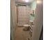 Compact bathroom with shower/tub combo and tropical-themed decor and fixtures at 6162 Redwing Ave, Englewood, FL 34224