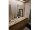 Bathroom featuring a sink and vanity with extra storage below, mirror and lace curtains at 6162 Redwing Ave, Englewood, FL 34224