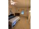 Cozy bedroom featuring carpeted floors, dresser, and a large bed with a ceiling fan to keep cool at 6162 Redwing Ave, Englewood, FL 34224