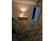 Bedroom featuring a bed and nightstand, as well as a doorway that leads to another room at 6162 Redwing Ave, Englewood, FL 34224
