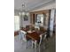 Traditional dining room with wooden table, chairs, buffet, and chandelier, ideal for gatherings at 6162 Redwing Ave, Englewood, FL 34224