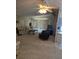 Cozy living room featuring carpeted floors, large windows, fan and comfortable furniture at 6162 Redwing Ave, Englewood, FL 34224