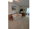 Living room with a comfortable sofa, carpeted floors, and neutral decor with a doorway leading to another room at 6162 Redwing Ave, Englewood, FL 34224