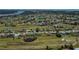Panoramic aerial view of a community featuring well-maintained homes, scenic ponds, and lush golf course fairways at 62 Oakland Hills Pl, Rotonda West, FL 33947