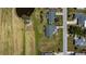 Birds-eye view of property showcasing lawn and landscaping, in a neighborhood with a nearby pond at 62 Oakland Hills Pl, Rotonda West, FL 33947