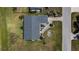 Aerial view of a home featuring neat landscaping, well-kept lawns and a paved driveway at 62 Oakland Hills Pl, Rotonda West, FL 33947