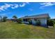 A well-manicured lawn, with lovely landscaping and a screened-in lanai, providing an ideal outdoor retreat at 62 Oakland Hills Pl, Rotonda West, FL 33947