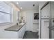 Bathroom with granite countertops, tiled shower, and modern fixtures offers accessible design at 62 Oakland Hills Pl, Rotonda West, FL 33947