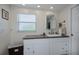 Bathroom featuring granite countertops, built-in storage, and natural light from the window at 62 Oakland Hills Pl, Rotonda West, FL 33947