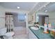 Spacious bathroom featuring a jetted tub, separate vanity, and decorative tile accents at 62 Oakland Hills Pl, Rotonda West, FL 33947
