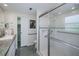 Modern bathroom with a glass-enclosed shower and grab bars for accessibility at 62 Oakland Hills Pl, Rotonda West, FL 33947