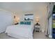 Cozy bedroom with a queen bed, bedside tables, and serene views from the window at 62 Oakland Hills Pl, Rotonda West, FL 33947