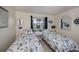 Comfortable bedroom with matching twin beds, nautical decor, and sunlit window views at 62 Oakland Hills Pl, Rotonda West, FL 33947