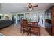 Elegant dining room with wooden table and chairs adjacent to living room and screened-in patio at 62 Oakland Hills Pl, Rotonda West, FL 33947