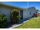 Back yard of home featuring lush greenery, a well-maintained lawn, and the freshly painted exterior at 62 Oakland Hills Pl, Rotonda West, FL 33947