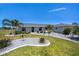 Charming home featuring a well-manicured lawn, elegant landscaping, and a beautiful, freshly-painted exterior at 62 Oakland Hills Pl, Rotonda West, FL 33947