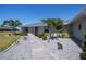 Inviting home featuring lush landscaping, a serene yard, and a pristine, freshly-painted exterior at 62 Oakland Hills Pl, Rotonda West, FL 33947