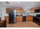 Spacious kitchen with stainless steel appliances and wood cabinetry at 62 Oakland Hills Pl, Rotonda West, FL 33947