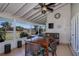 Enclosed lanai with comfortable seating and views of the lush green outdoors at 62 Oakland Hills Pl, Rotonda West, FL 33947