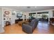 Bright living room with a stylish couch, sleek flooring, and large sliding doors offering an inviting atmosphere at 62 Oakland Hills Pl, Rotonda West, FL 33947
