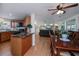 Open floor plan featuring kitchen with wooden cabinets and a living room with modern furnishings and decor at 62 Oakland Hills Pl, Rotonda West, FL 33947