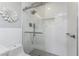 Shower featuring white subway tile with glass door and rain style shower head at 6375 Coniston St, Port Charlotte, FL 33981
