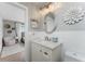 Bathroom featuring a vanity with granite countertop, modern fixtures, and a decorative mirror at 6375 Coniston St, Port Charlotte, FL 33981