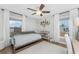 Bright bedroom with hardwood floors, ample natural light, ceiling fan, and decorative shelving at 6375 Coniston St, Port Charlotte, FL 33981