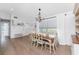 Bright dining area with wood table, white chairs, and ample natural light, ideal for Gathering meals and gatherings at 6375 Coniston St, Port Charlotte, FL 33981