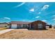 Attractive single-story home with a stone facade, a well-maintained yard, and an attached garage at 6375 Coniston St, Port Charlotte, FL 33981